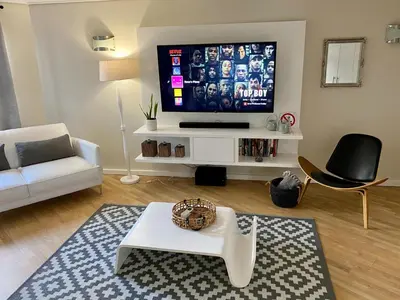 a living room with a flat screen tv and a couch at Rose’s Place in Durbanville