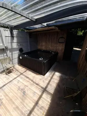 a large black tub sitting on a patio at Rose’s Place in Durbanville