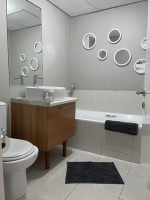 a bathroom with a sink and a toilet and a tub at 104 Horizon Bay Bloubergstrand in Bloubergstrand