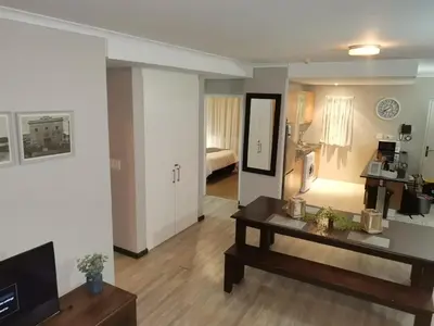 a living room with a couch and a table in a room at 104 Horizon Bay Bloubergstrand in Bloubergstrand