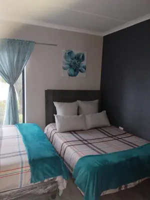 a bedroom with a bed and a window at Cederberg Estate in Cape Town