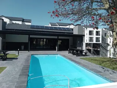 a swimming pool in the backyard of a house at Cederberg Estate in Cape Town