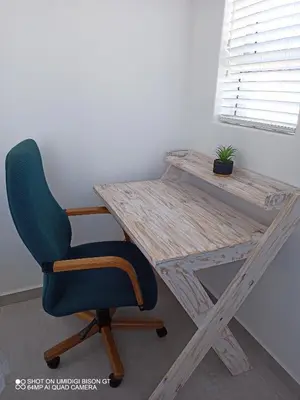 a wooden desk with a chair and a plant at Stay Palm 1 in Cape Town