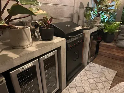 an outdoor kitchen with an oven and potted plants at Green Oasis in Blouberg Hot Tub Kids Paradise in Cape Town