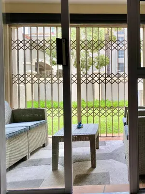 a living room with a couch and a table at The CoziPlace Italia in Cape Town