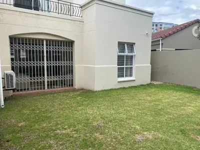 a house with a gate in the yard at The CoziPlace Italia in Cape Town