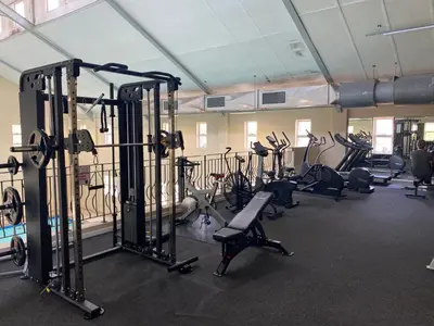 a gym with several treadmills and exercise bikes at The CoziPlace Italia in Cape Town
