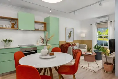 a kitchen and living room with a table and chairs at The Tram Stop in Franschhoek