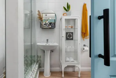 a bathroom with a sink and a glass shower at The Tram Stop in Franschhoek