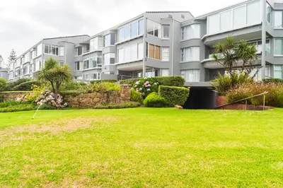 an apartment building with a lawn in front of it at Bayview 305A in Hermanus