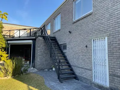 a stairway leading up to a brick building at Silver Sunsets Self-Catering Apartments in Cape Town