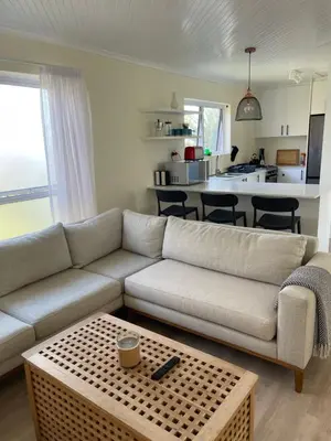 a living room with a couch and a table at Silver Sunsets Self-Catering Apartments in Cape Town