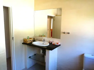 a bathroom with a sink and a mirror at Gästehaus HelderbergView in Somerset West