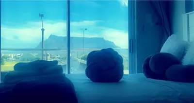 a room with a bed with a view of a window at Kwaaami in Cape Town
