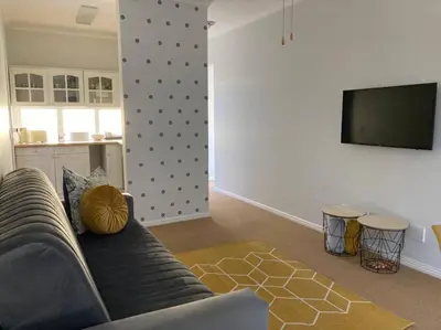 a living room with a couch and a flat screen tv at Johan-nest in Cape Town