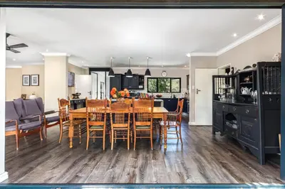 a kitchen and dining room with a table and chairs at Luxury Stellenbosch Villa in Stellenbosch