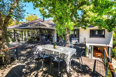 a table and chairs in front of a house at Luxury Stellenbosch Villa in Stellenbosch