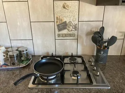 a stove top with a pot on top of it at The Elephant House in Cape Town