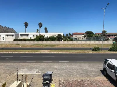 a white truck parked on the side of a road at The Elephant House in Cape Town