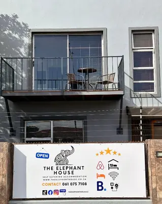 a building with a balcony and a sign in front of it at The Elephant House in Cape Town