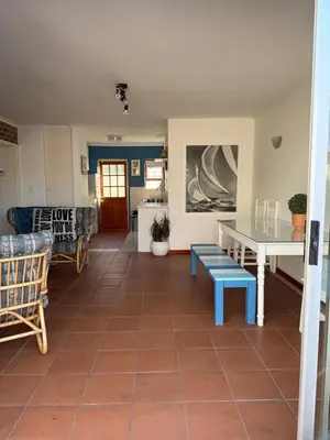 a living room with a tiled floor and a table and chairs at Coastal House: 3BR+Private Entrance+Self catering in Cape Town