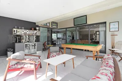 a living room with a pool table in it at On 8th Green Worthing Villa in Cape Town