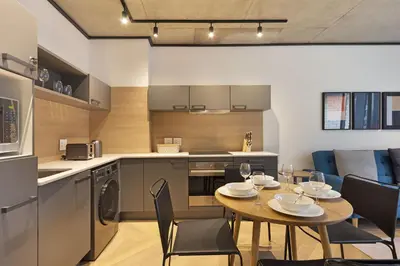 a kitchen and dining room with a table and chairs at Bridgewater View 415 in Cape Town