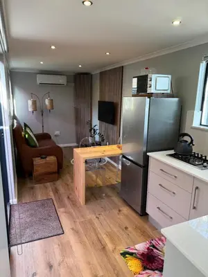 a kitchen with a refrigerator and a table in it at The Leopard Leaf Inn in Cape Town