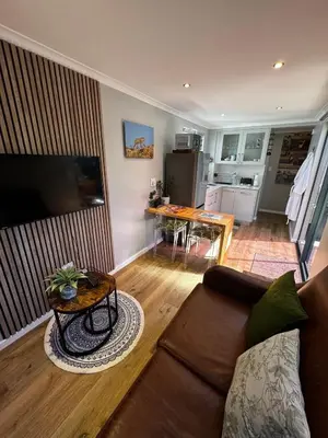 a living room with a couch and a table at The Leopard Leaf Inn in Cape Town