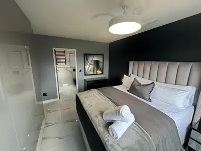 a bedroom with a large bed with towels on it at Exclusive Ultra-Luxury A Cut Above Apartments Century City by Vvip Bookings in Cape Town