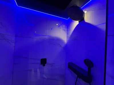 a room with a blue light and a black chair at Exclusive Ultra-Luxury A Cut Above Apartments Century City by Vvip Bookings in Cape Town