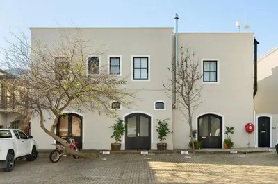 a white building with a car parked in front of it at Luxury Winetram getaway in Franschhoek