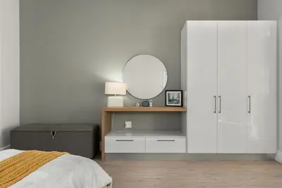 a bedroom with a white cabinet and a mirror at Luxury Winetram getaway in Franschhoek