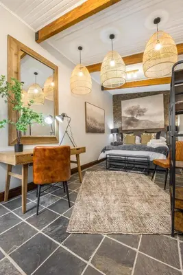 a bedroom with a bed and a desk and a table at Avemore Time Out - full power back up in Stellenbosch