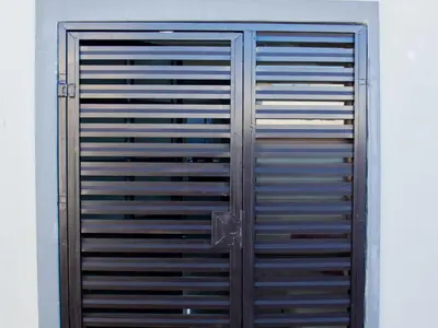 a pair of metal garage doors on a wall at Maseyi On 8 bnb in Cape Town