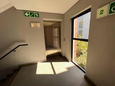 an empty hallway with a door and a window at Modern Apartment in Stellenbosch in Stellenbosch