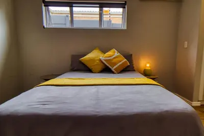 a bedroom with a bed with two pillows on it at Magnificent Villa Load-Shedding Free! in Cape Town