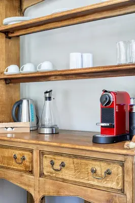 a red appliance sitting on top of a wooden cabinet at Loft de L'Opera - Franschhoek in Franschhoek