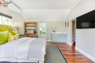 a bedroom with a bed and a television in it at Loft de L'Opera - Franschhoek in Franschhoek
