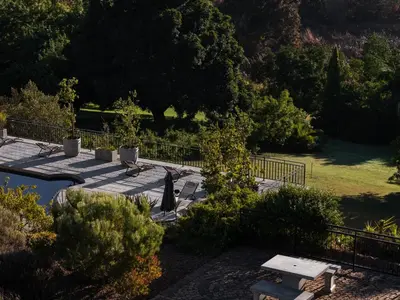 a picnic table and benches in a park at Avemore Olive Apartment - full Backup power in Stellenbosch