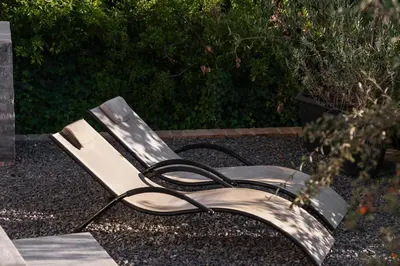 a bench sitting on the ground in a garden at Avemore Hidden Haven - wood fired hot tub and full Backup power in Stellenbosch