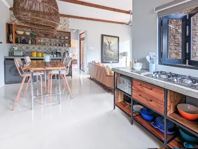 a kitchen and living room with a table and chairs at Tulbagh Mountain Bungalow in Wolseley