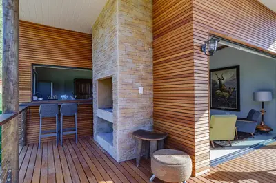 a patio with a bar on a wooden deck at Tulbagh Mountain Bungalow in Wolseley