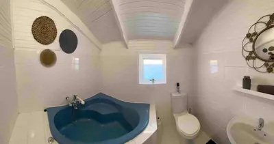 a bathroom with a blue tub in the middle at Prometheus in Lake Marina