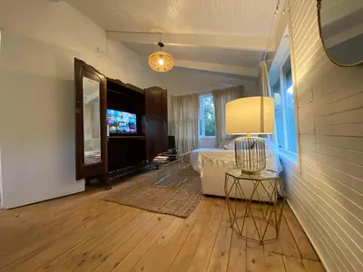 a bedroom with a bed and a table and a lamp at Prometheus in Lake Marina
