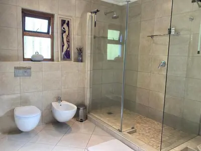 a bathroom with a shower and a toilet and a sink at Goldeneye Private Venue Spectre in Raithby