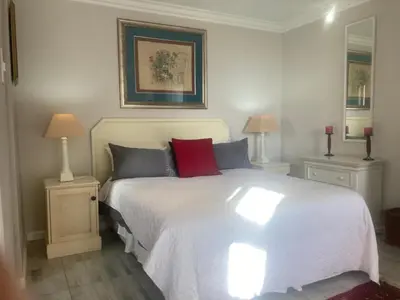 a bedroom with a large white bed with two night stands at Goldeneye Private Venue Spectre in Raithby