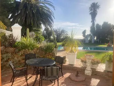 a patio with a table and chairs and a pool at Goldeneye Private Venue Spectre in Raithby