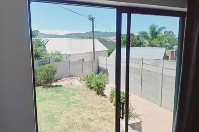 an open window with a view of a fence at Cosy Nest - Uncapped Wi-fi & Self Check-in in Cape Town