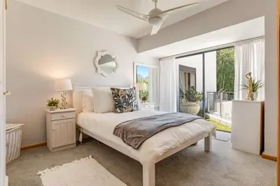 a bedroom with a bed and a large window at Erinvale Luxury Villa in Cape Town